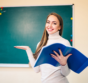 Female teacher in front of chalk board